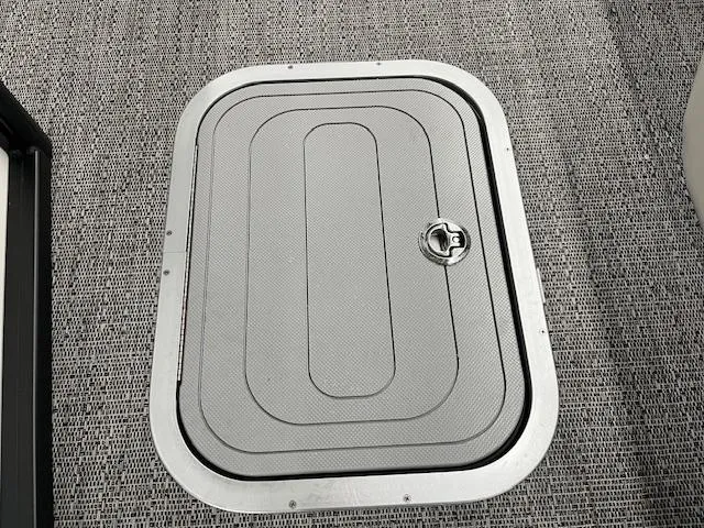 Slide: The Image of Hatch door on Barletta Lusso 25UC 2025 boat, featuring textured surface and secure latch. - 27
