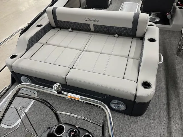 Slide: The Image of 2025 Barletta Lusso 25UC boat interior with luxurious seating and cup holders. - 5