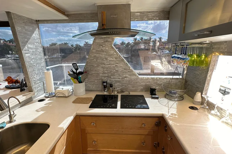 Slide: The Image of Modern kitchen in a 1988 Viking Motor Yacht with sleek countertops and large windows. - 41