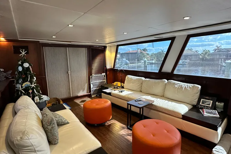 Slide: The Image of Luxurious interior of a 1988 Viking Motor Yacht with white sofas and large windows. - 43