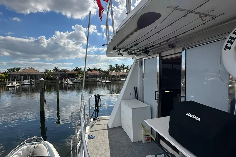 Slide: The Image of 1988 Viking Motor Yacht docked at a marina with a scenic waterfront view. - 49