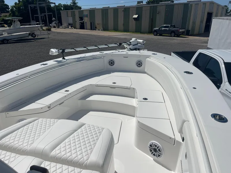 Slide: The Image of 2026 Regulator 30XO boat with white seating and modern design in a marina setting. - 10