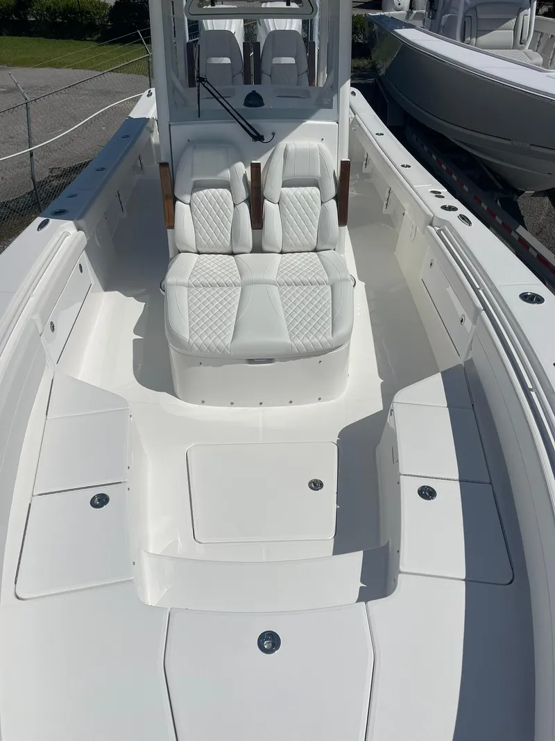 Slide: The Image of 2026 Regulator 30XO boat interior with white seating and spacious deck layout. - 12
