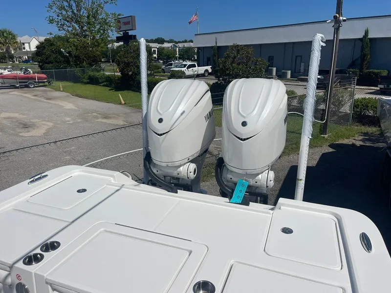 Slide: The Image of 2026 Regulator 30XO boat with dual Yamaha outboard engines in a parking lot. - 16