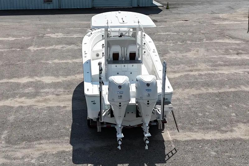 Slide: The Image of 2026 Regulator 30XO boat with dual 350 horsepower engines, parked on a concrete surface. - 20