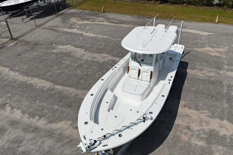 Slide: The Image of 2026 Regulator 30XO boat in a parking area, aerial view. - 21