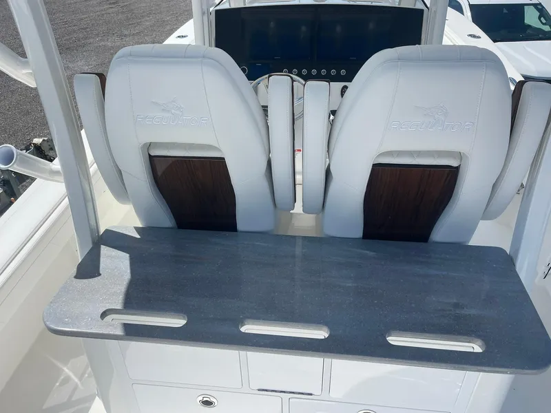 Slide: The Image of 2026 Regulator 30XO boat interior with white seats and control panel. - 4