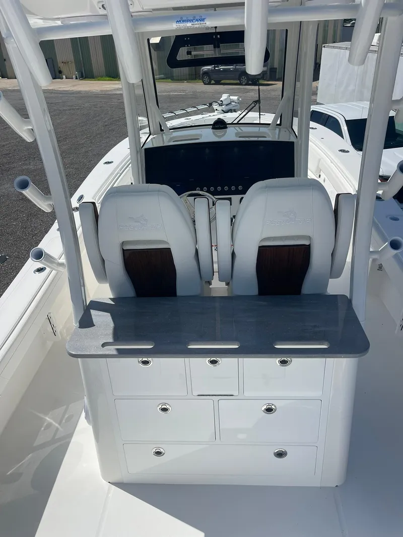 Slide: The Image of 2026 Regulator 30XO boat cockpit with dual seats and storage drawers. - 5