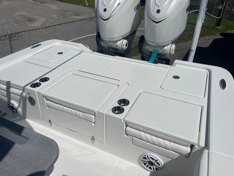 Slide: The Image of 2026 Regulator 30XO boat deck with dual Yamaha engines, featuring storage and cup holders. - 6