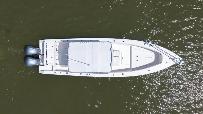 Slide: The Image of Aerial view of 1999 Island Runner 31 boat on water with twin engines. - 13