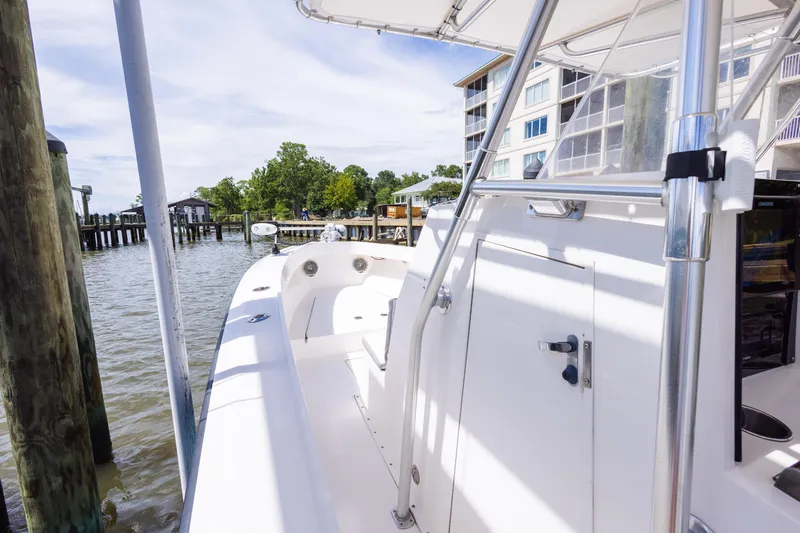 Slide: The Image of 1999 Island Runner 31 boat docked near waterfront buildings and trees. - 18