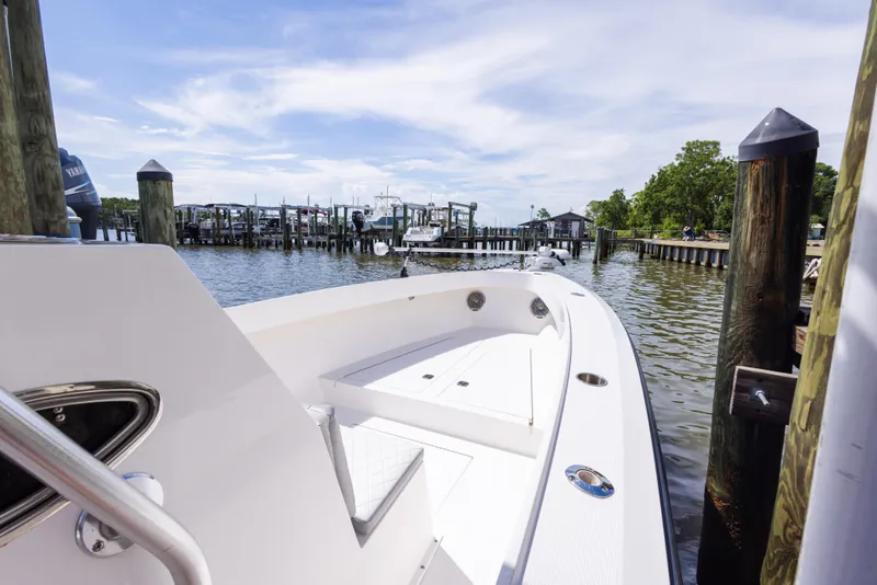 Slide: The Image of 1999 Island Runner 31 boat docked at a marina with clear skies. - 19