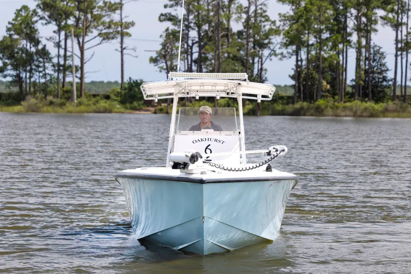 Slide: The Image of 1999 Island Runner 31 boat on water, with trees in the background. - 2