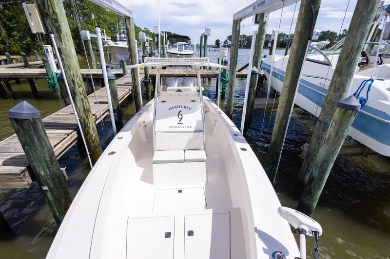 Slide: The Image of 1999 Island Runner 31 boat docked at marina, surrounded by other boats and wooden piers. - 20