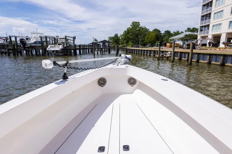 Slide: The Image of 1999 Island Runner 31 boat docked near waterfront buildings and marina. - 23