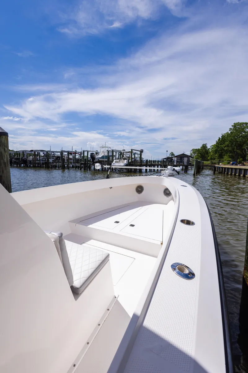Slide: The Image of 1999 Island Runner 31 boat docked at marina under clear blue sky. - 24