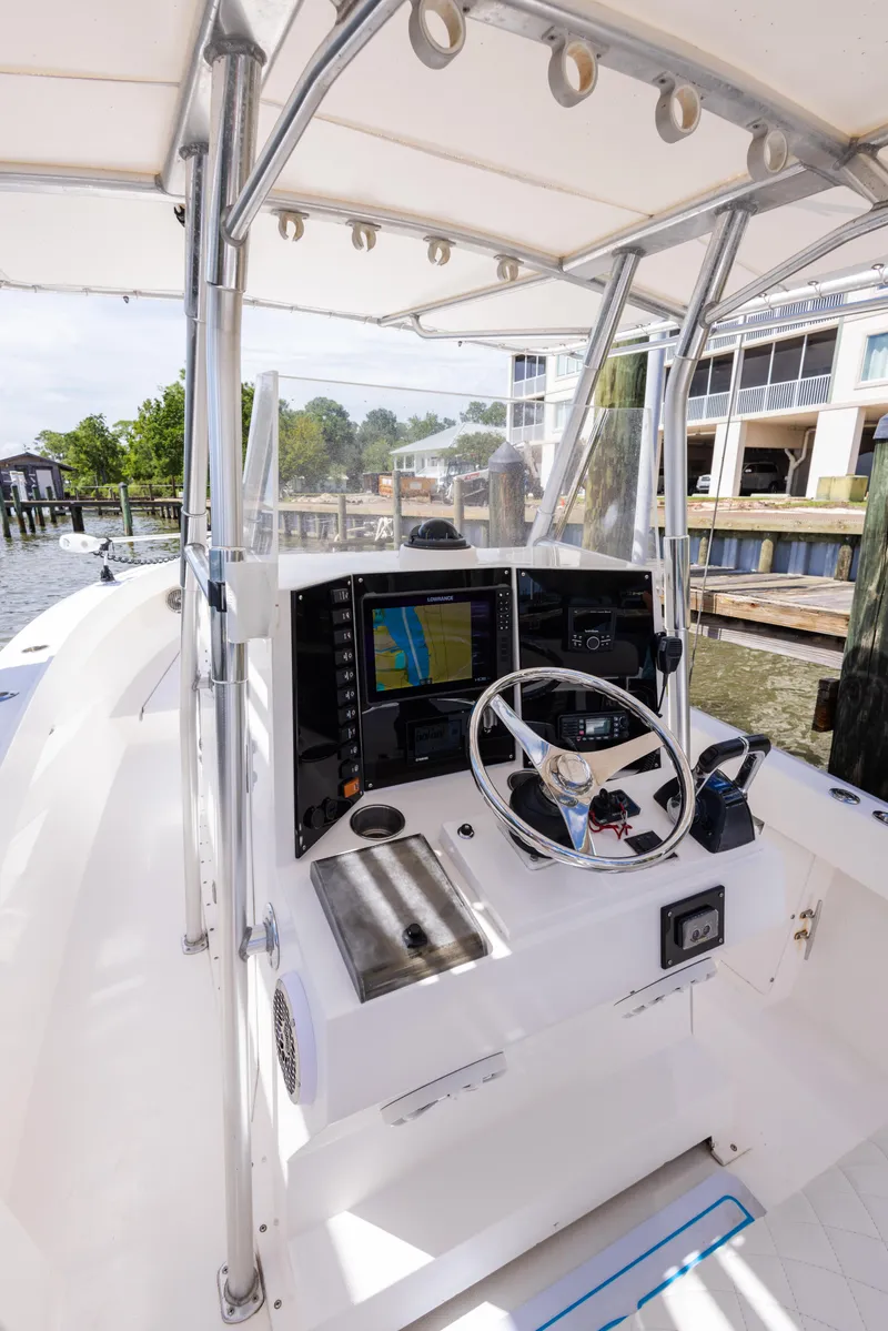 Slide: The Image of 1999 Island Runner 31 boat cockpit with steering wheel and navigation system. - 26