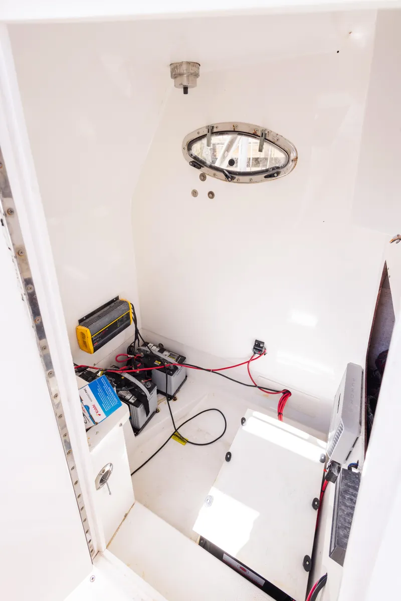 Slide: The Image of Interior of 1999 Island Runner 31 boat showing electrical components and wiring. - 27