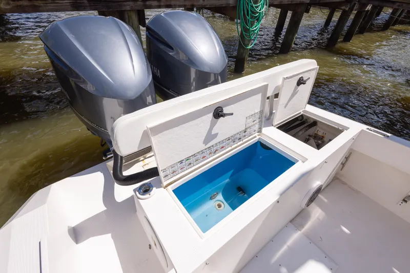 Slide: The Image of 1999 Island Runner 31 boat with dual engines and open storage compartments. - 29