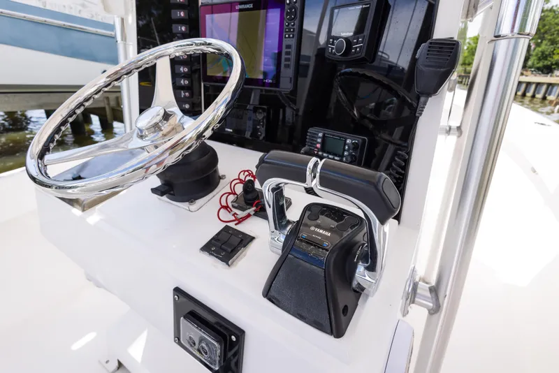 Slide: The Image of 1999 Island Runner 31 boat console with steering wheel and navigation controls. - 33