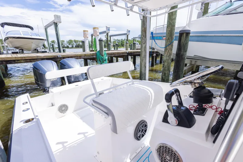 Slide: The Image of 1999 Island Runner 31 boat interior with dual engines, docked at marina. - 34