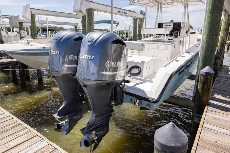 Slide: The Image of 1999 Island Runner 31 boat with twin Yamaha 300 engines docked at marina. - 37