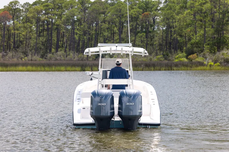 Slide: The Image of 1999 Island Runner 31 boat with dual 300 horsepower engines on a calm lake. - 7