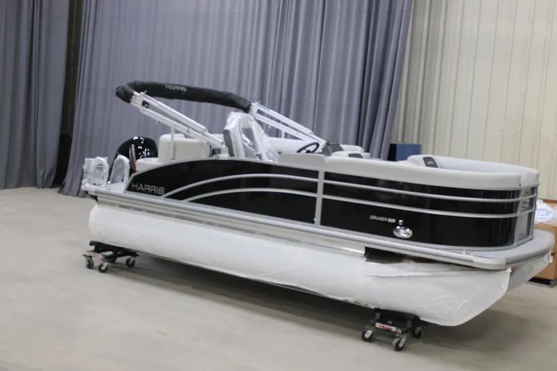 The Image of 2025 Harris Cruiser 190 pontoon boat in a showroom, wrapped for protection. - 0