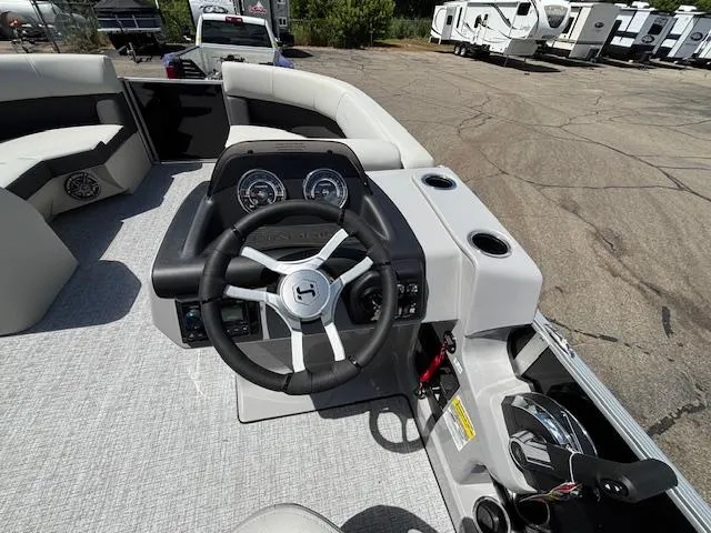 Slide: The Image of 2025 Harris Cruiser 190 boat dashboard with steering wheel and controls. - 10