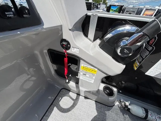 Slide: The Image of 2025 Harris Cruiser 190 boat dashboard with controls and safety features. - 11