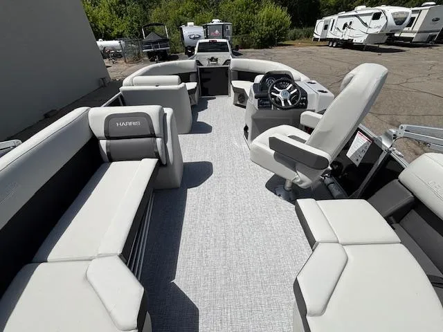 Slide: The Image of 2025 Harris Cruiser 190 pontoon boat interior with plush seating and modern steering console. - 13