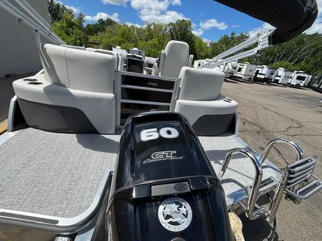 Slide: The Image of 2025 Harris Cruiser 190 boat with 60 HP engine, docked outdoors under a clear sky. - 5