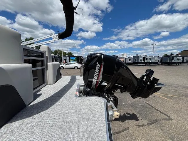 Slide: The Image of 2025 Harris Cruiser 190 boat with Mercury outboard motor under a blue sky. - 6