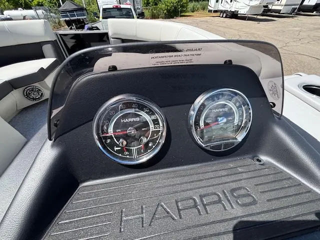 Slide: The Image of Dashboard of 2025 Harris Cruiser 190 boat with gauges and seating area. - 8