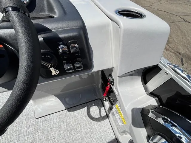 Slide: The Image of 2025 Harris Cruiser 190 boat dashboard with steering wheel and control panel. - 9