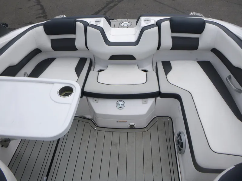 Slide: The Image of 2020 Yamaha Boats 195S interior with white and black seating, table, and cup holder. - 10