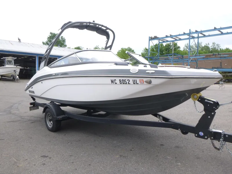 Slide: The Image of 2020 Yamaha Boats 195S on trailer, parked outdoors, showcasing sleek design and modern features. - 4