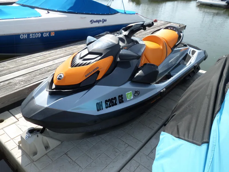 Slide: The Image of 2021 Sea-Doo GTI SE 170 jet ski docked by the water. - 1
