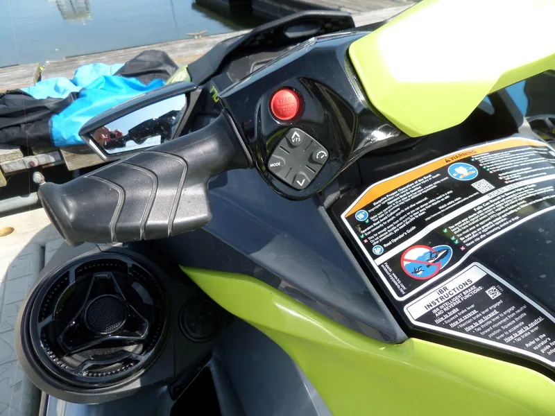 Slide: The Image of Close-up of 2021 Sea-Doo GTI SE 170 handlebar controls and safety instructions. - 11