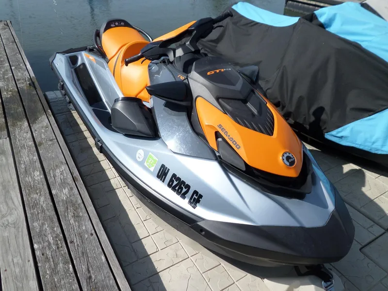 Slide: The Image of 2021 Sea-Doo GTI SE 170 jet ski docked, featuring orange and silver design. - 12