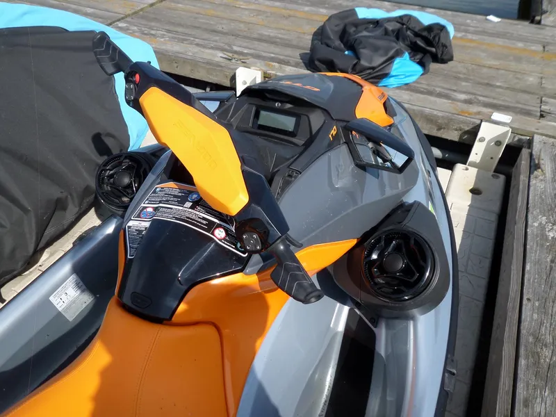 Slide: The Image of 2021 Sea-Doo GTI SE 170 jet ski with orange and gray design on a dock. - 13
