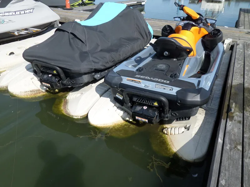 Slide: The Image of 2021 Sea-Doo GTI SE 170 jet ski docked, partially covered, on a floating platform. - 17