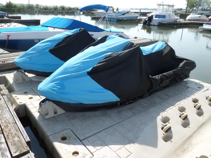 Slide: The Image of Two covered 2021 Sea-Doo GTI SE 170 jet skis docked at a marina. - 3