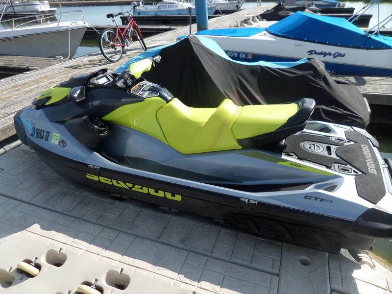 Slide: The Image of 2021 Sea-Doo GTI SE 170 jet ski docked at marina with vibrant yellow seat. - 5