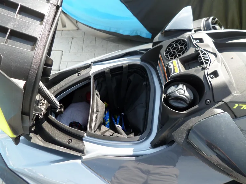 Slide: The Image of 2021 Sea-Doo GTI SE 170 storage compartment, open and partially filled. - 8