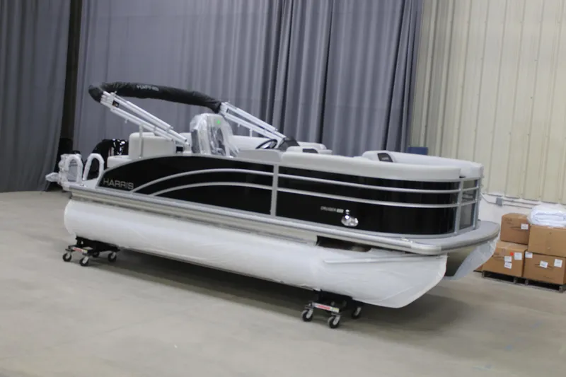 The Image of 2025 Harris Cruiser 190 pontoon boat in a showroom setting. - 0