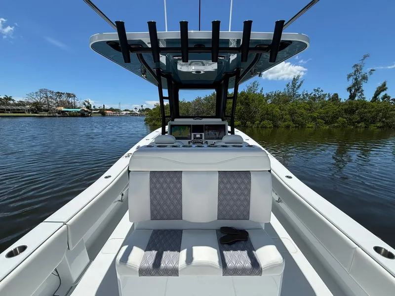 Slide: The Image of 2026 Invincible 36 Open Fisherman boat on calm water, featuring sleek seating and modern design. - 10