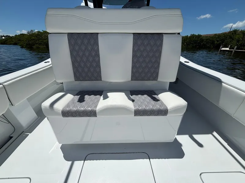 Slide: The Image of 2026 Invincible 36 Open Fisherman boat seat with gray and white upholstery. - 11