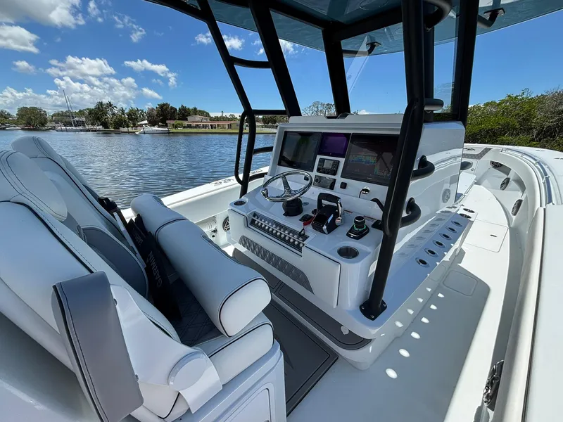 Slide: The Image of 2026 Invincible 36 Open Fisherman boat interior with advanced navigation system and luxurious seating. - 13