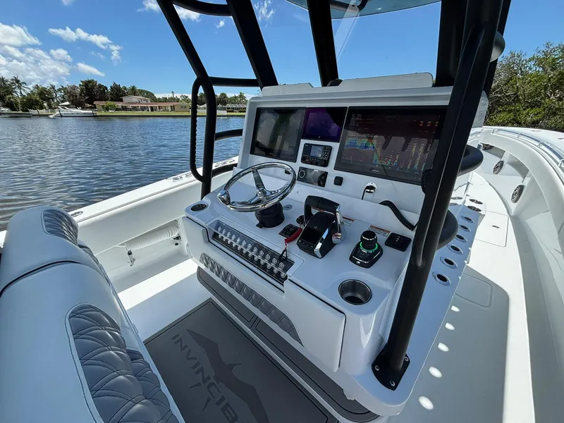 Slide: The Image of 2026 Invincible 36 Open Fisherman boat console with advanced navigation systems. - 14